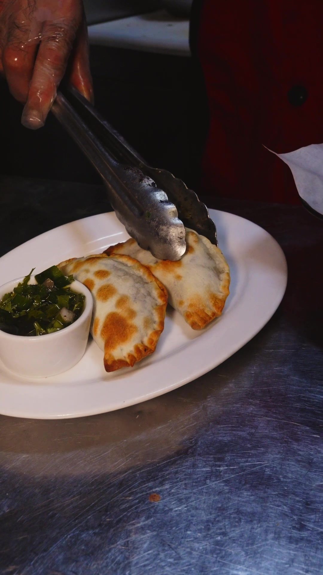 Empanadas servidas con chimichurri en Porteño