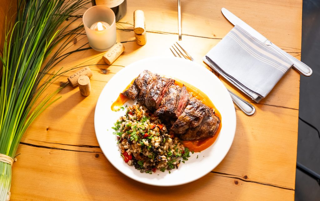 Grilled steak served with roasted vegetables at Porteño Restaurant in New York.