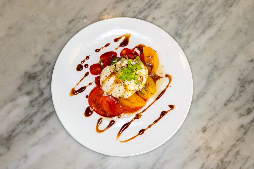 Heirloom tomato and burrata salad with balsamic glaze at a Manhattan steak house