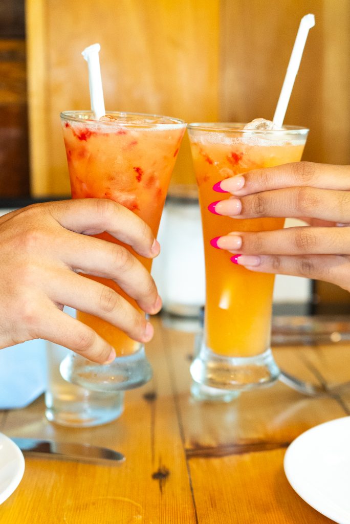 Two colorful fruit cocktails toasting at a steak house in Manhattan