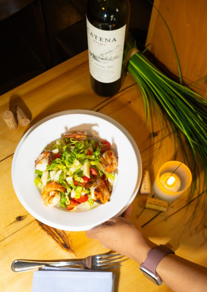 Salad on wood table at porteño