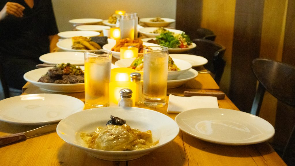 Long table set for a group dinner at Porteño Restaurant.