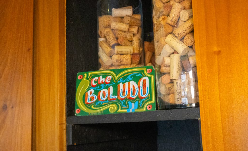 Decorative chalkboard sign with the word “Salud!” inside a restaurant.